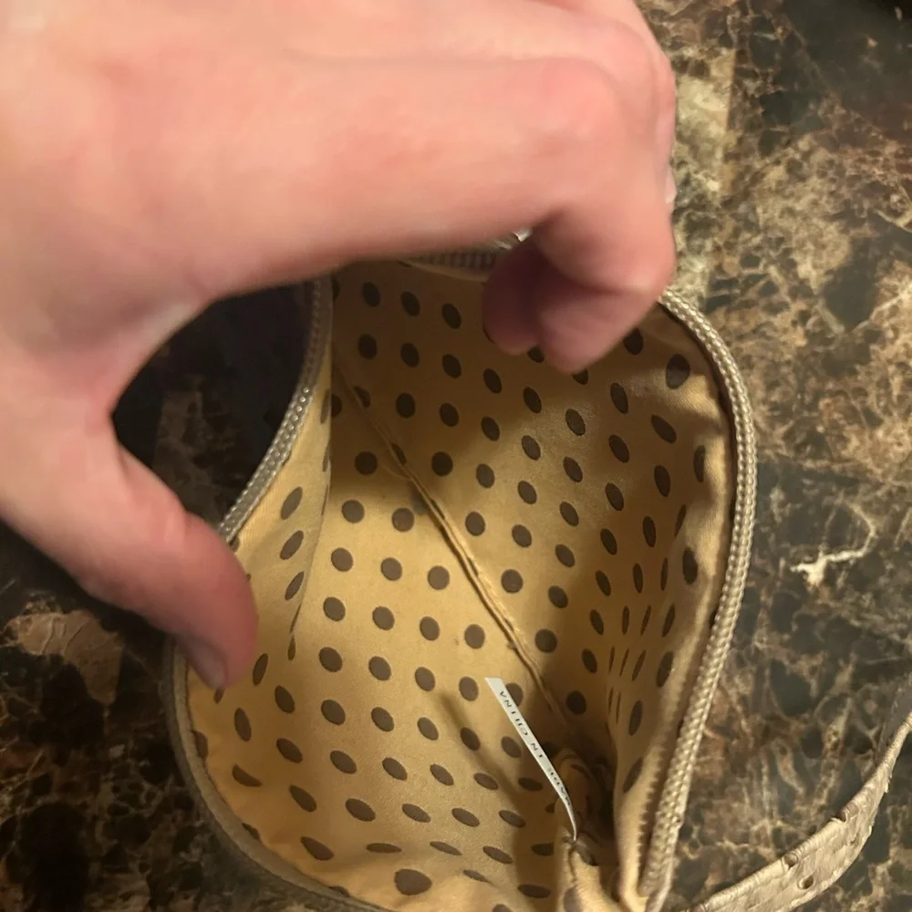 Beige Ostrich textured wristlet with polka dot lining